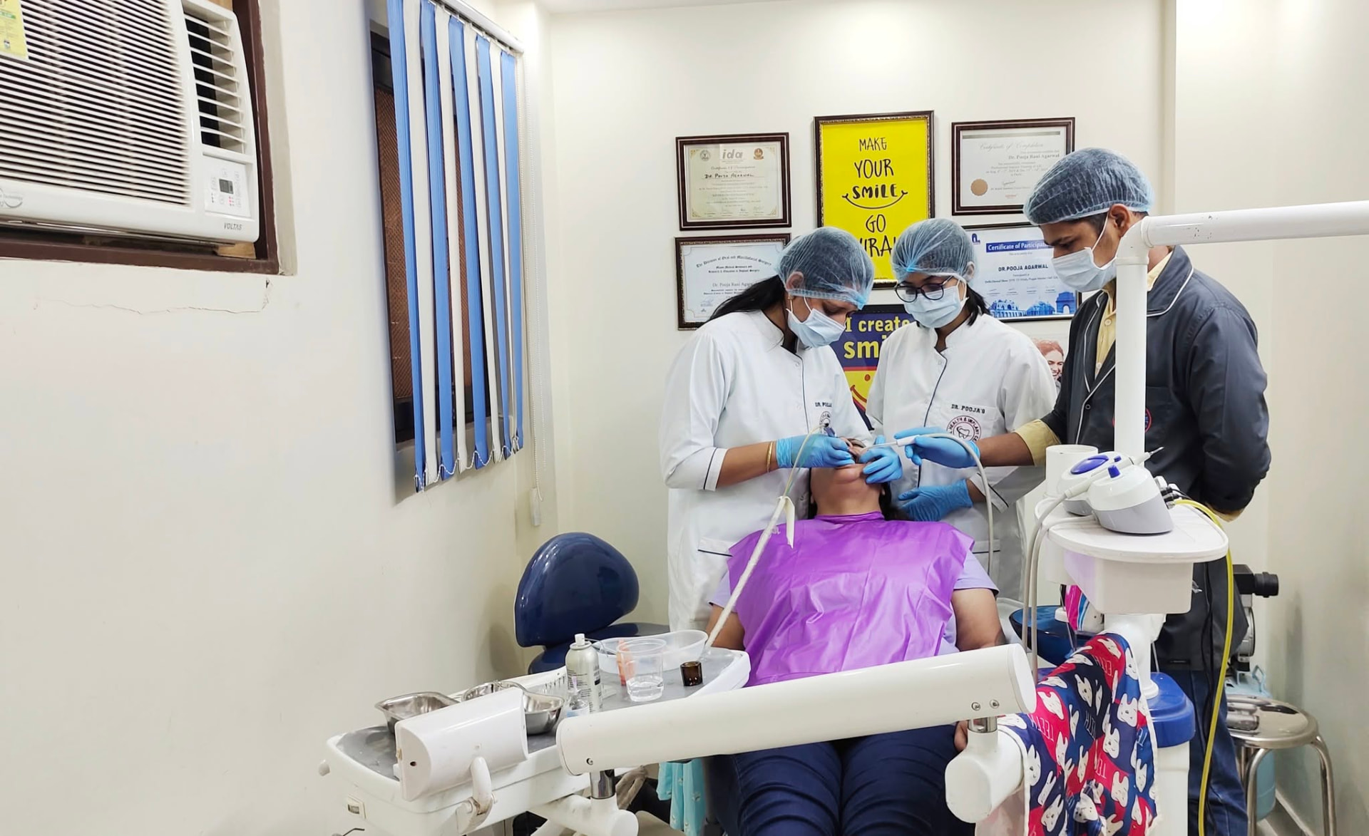 Dentists treating a patient at one of our partner clinics in India